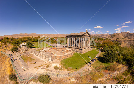 Aerial view of famous Garni pagan temple with Ionic-colonnaded. Historic Greek style building is located on gorge. Built in I century AD by Armenian king Trdat. Ancient Khosrov Reserve, Armenia Europe 122947713