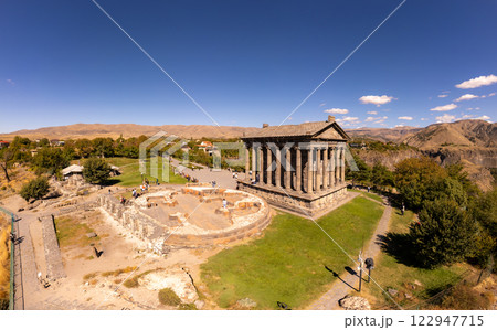 Aerial view of famous Garni pagan temple with Ionic-colonnaded. Historic Greek style building is located on gorge. Built in I century AD by Armenian king Trdat. Ancient Khosrov Reserve, Armenia Europe 122947715