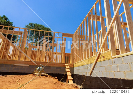 Erecting wooden frame of house under progress works showcasing progress in construction 122948482