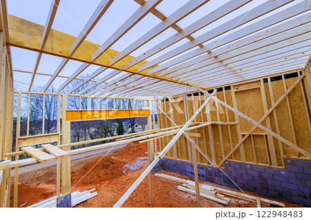 Construction are building wooden beams frame in rural setting, under works day 122948483