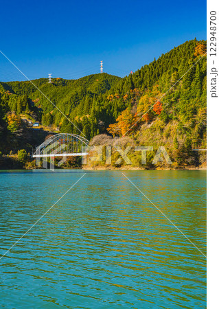 豊根村の新豊根ダムの紅葉に包まれたみどり湖の風景(愛知県) 122948700
