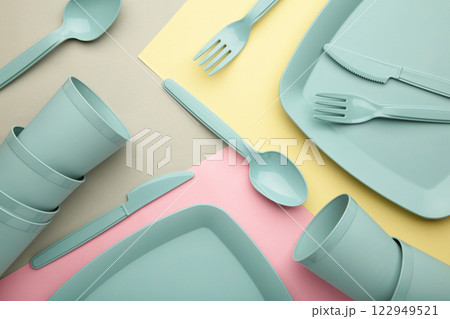 Bright plastic disposable tableware on colorful background. Bright plastic disposable tableware on colorful background. 122949521