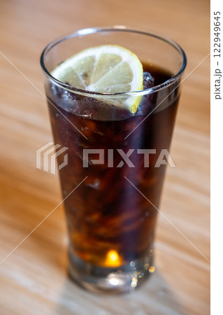 A glass of Cola with a slice of lemon on the table A glass of Cola with a slice of lemon on the table 122949645