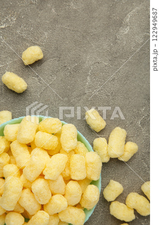 Sweet corn sticks in bowl on grey background. Vertical photo. 122949687