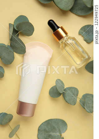 Organic skin care products on beige background with fresh green eucalyptus leaves. Organic skin care products on beige background with fresh green eucalyptus leaves. 122949725