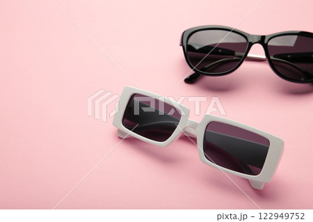 White and black sunglasses on pink background, top view, flat lay, minimalistic concept of summer, vacation 122949752
