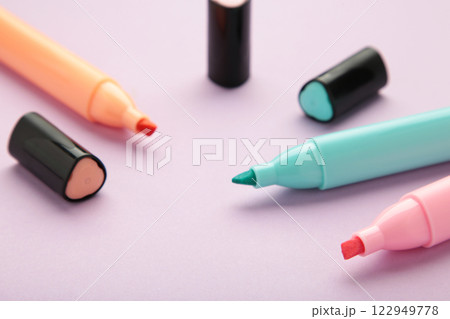 Open markers and space for text on purple background. 122949778