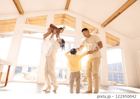Korean young parents dancing with cute little kids in dining room Korean young parents dancing with cute little kids in dining room 122950042