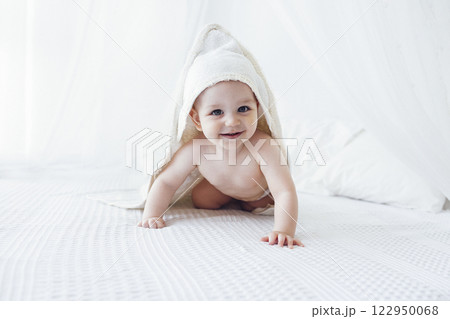 Little cute child wearing hooded towel after bath or shower. Little cute child wearing hooded towel after bath or shower. 122950068