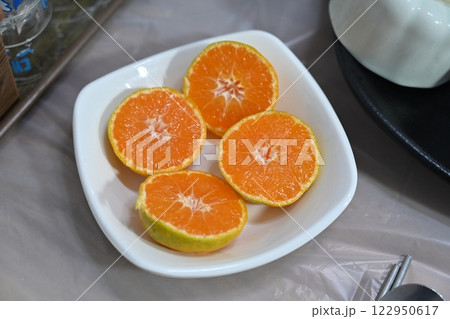 halved orange on a plate 122950617