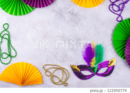 Vibrant Mardi Gras background with mask, beads, and festive decorations 122950774