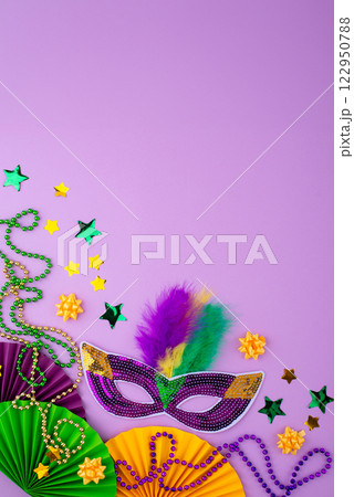 Vibrant Mardi Gras background with mask, beads, and festive decorations 122950788