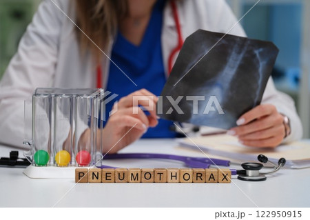 Doctor Conducting an InDepth Analysis of Chest XRay for Accurate Pneumothorax Diagnosis 122950915