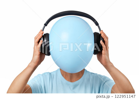 woman hides her face behind balloon with headphones on white background woman hides her face behind balloon with headphones on white background 122951147