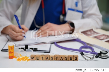 A Medical Professional Conducting a Thorough Analysis of Metastases in a Clinical Setting A Medical Professional Conducting a Thorough Analysis of Metastases in a Clinical Setting 122951312