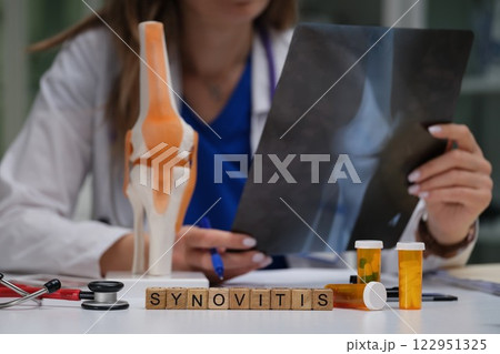 A Doctor Conclusively Analyzing a Knee Xray for Accurate Synovitis Diagnosis and Treatment 122951325