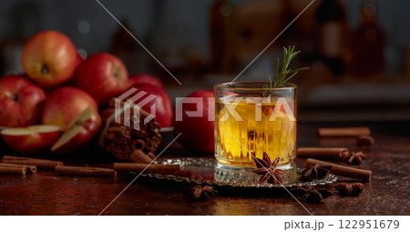 Apple cider with apple slices and a rosemary sprig. Apple cider with apple slices and a rosemary sprig. 122951679