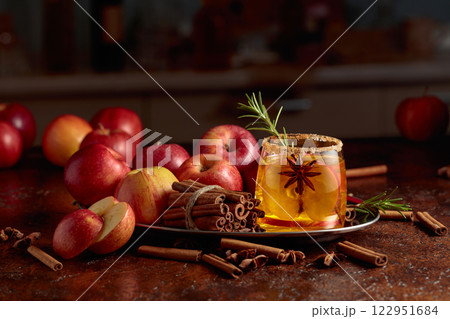 Apple cider with apple slices, anise, and a rosemary branch. 122951684