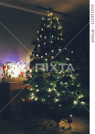 Christmas Tree with Book and Nativity Scene Festive Holiday Decorations and Cozy Seasonal Atmosphere. High quality photo 122951959