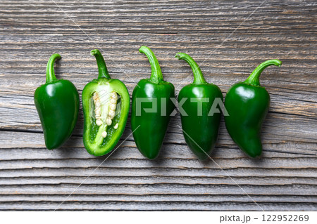 Green mexican jalapeno hot peppers placed in a row 122952269