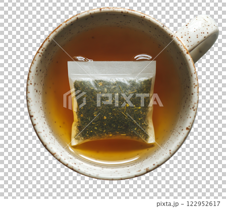 Tea brewing in a ceramic cup with a tea bag submerged in warm water 122952617