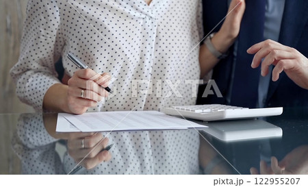 Businesspeople in a meeting with calculator. Sexual harassment is strictly prohibited in the workplace 122955207