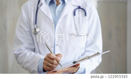Female doctor filling medical form on clipboard, writing prescription, making notes. Medicine and science Female doctor filling medical form on clipboard, writing prescription, making notes. Medicine and science 122955585