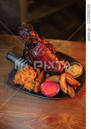 Juicy baked pork knuckle served beautifully on a 122956228