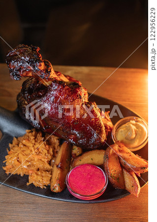Juicy baked pork knuckle served beautifully on a Juicy baked pork knuckle served beautifully on a 122956229