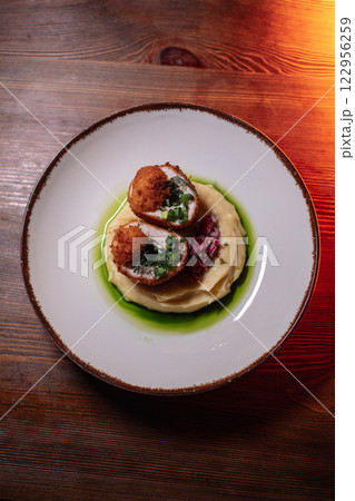 Delicious cutlets with airy mashed potatoes served Delicious cutlets with airy mashed potatoes served 122956259