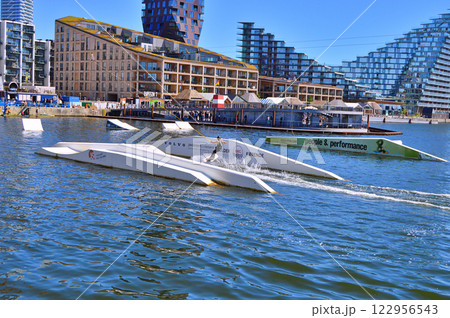 Man wakeboarding in front of modern residential neighborhood at Aarhus in Denmark 122956543