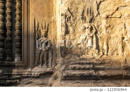 Carved statues of dancing apsaras celestial nymphs on the walls of Angkor Wat, Siem Reap, Cambodia 122956964