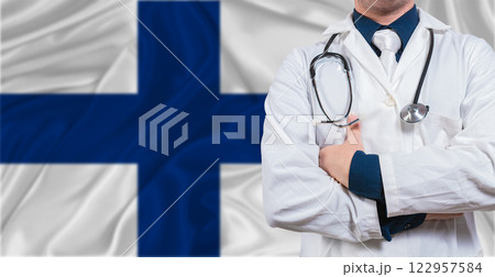 Male doctor with stethoscope on Finland flag. Doctor holding stethoscope on Finland flag Male doctor with stethoscope on Finland flag. Doctor holding stethoscope on Finland flag 122957584