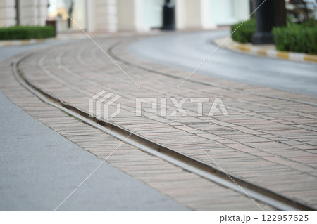 Curved Tramway Tracks Are Laid on a Beautiful Cobblestone Pathway Curved Tramway Tracks Are Laid on a Beautiful Cobblestone Pathway 122957625