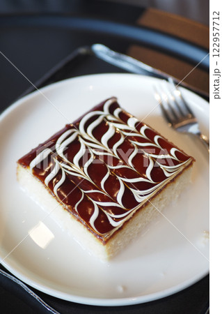 Delicious dessert served on a plate in a cozy setting Delicious dessert served on a plate in a cozy setting 122957712