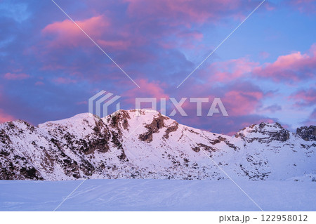 Snowy Mountain Peak at Sunset with Pink Clouds near Piani di Bobbio in Italy 122958012
