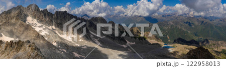 Expansive Panoramic View of Mountain Range Under Cloudy Sky.. 122958013