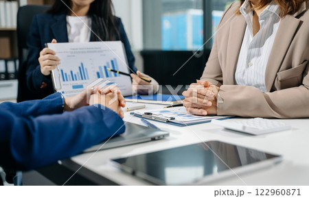 Businessman and team analyzing financial statement Finance task. with smart phone and laptop and tablet. Businessman and team analyzing financial statement Finance task. with smart phone and laptop and tablet. 122960871