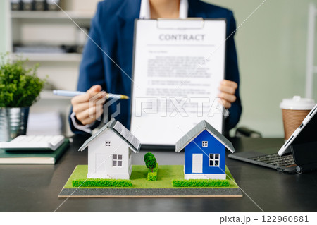 Considering buying a home, investing in real estate. Broker signs a sales agreement. agent, lease agreement, successful 122960881