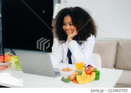 Professional nutritionist reviewing fresh vegetables and supplements for diet planning, health care Professional nutritionist reviewing fresh vegetables and supplements for diet planning, health care 122962705