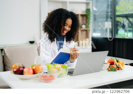 Professional nutritionist reviewing fresh vegetables and supplements for diet planning, health care Professional nutritionist reviewing fresh vegetables and supplements for diet planning, health care 122962706
