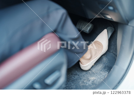Female driver in high heels, business woman driving car and pushing car break and accelerator pedal. Safety concept 122963378