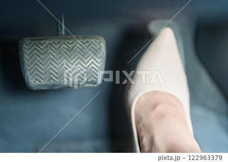 Female driver in high heels, business woman driving car and pushing car break and accelerator pedal. Safety concept 122963379