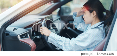 woman feeling stress and angry during drive car long time. Asian girl tired and fatigue having headache after driving car in traffic jam. Sleepy, stretching and drunk concept woman feeling stress and angry during drive car long time. Asian girl tired and fatigue having headache after driving car in traffic jam. Sleepy, stretching and drunk concept 122963380