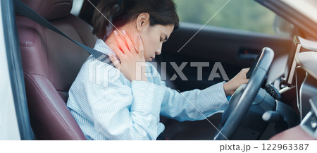 woman with her shoulder and neck sprain while driving car long time, muscle painful. Shoulder ache, Scapular pain, office syndrome and ergonomic concept woman with her shoulder and neck sprain while driving car long time, muscle painful. Shoulder ache, Scapular pain, office syndrome and ergonomic concept 122963387