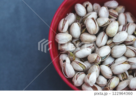 Delicious Pistachios in a Deep Red Bowl Close-up Delicious Pistachios in a Deep Red Bowl Close-up 122964360