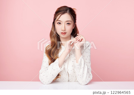 Beautiful young asian woman with clean fresh skin on pink background, Face care, Facial treatment, Cosmetology, beauty and spa, Asian women portrait. 122964565