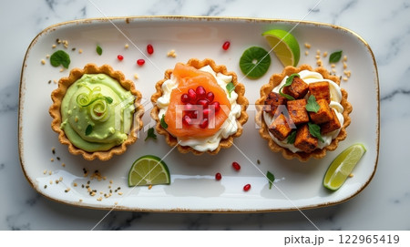 Delightful tartlets featuring avocado mousse, salmon, and kimchi tofu 122965419