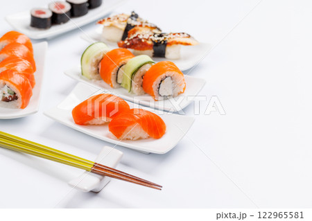 Assorted sushi and maki rolls beautifully arranged on plates 122965581