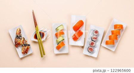 Assorted sushi and maki rolls beautifully arranged on plates 122965600
